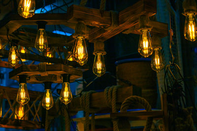 Low angle view of illuminated lanterns hanging in building