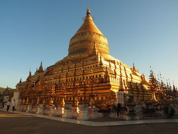 Golden shwezigon pagoda against sky