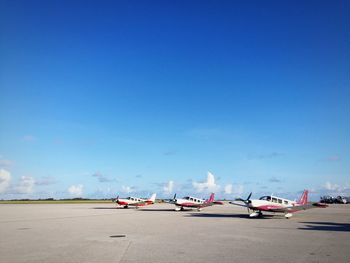 Airplane on airport runway against blue sky