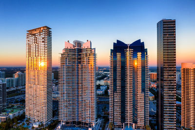 Panoramic view of illuminated buildings against sky during sunset