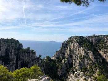 Scenic view of sea and mountains against sky