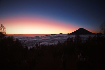 Scenic view of silhouette mountains against clear sky at sunset