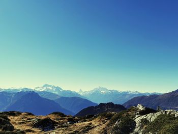 Scenic view of mountains against clear blue sky