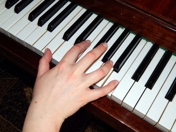 Cropped image of person playing piano