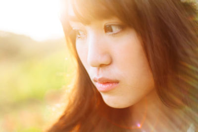 Close-up portrait of a beautiful young woman looking away