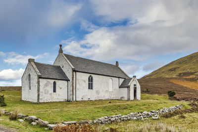 House on field against sky