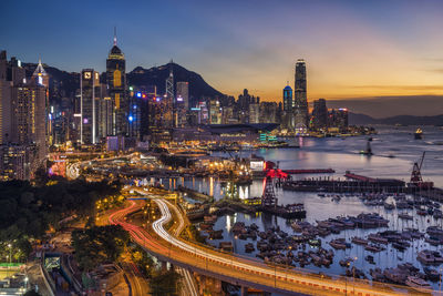 High angle view of illuminated buildings against sky at night