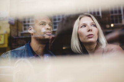 Couple looking away in coffee shop