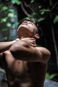 Shirtless man standing outdoors