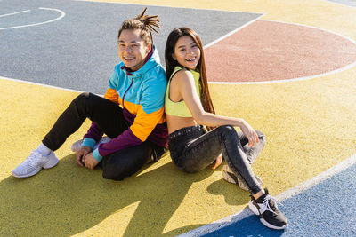 Portrait of young woman exercising on field