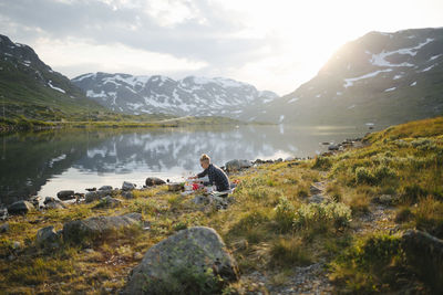 Woman camping at mountain lake