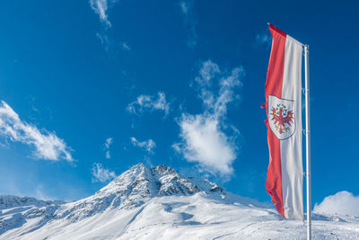 Scenic view of snowcapped mountains against blue sky