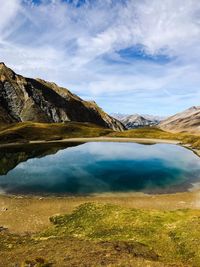 Scenic view of lake against cloudy sky