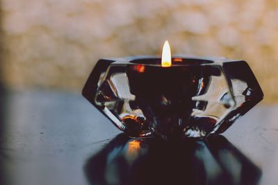 Close-up of tea light candle on table