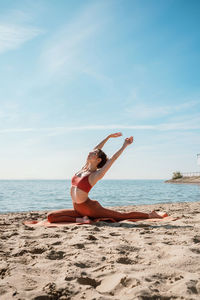 Full length of woman on beach against sky