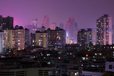 View of skyscrapers lit up at night