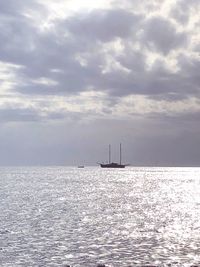 Sailboat sailing on sea against sky