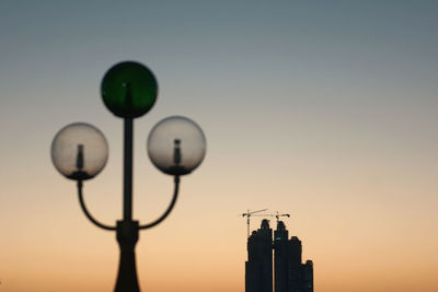 Low angle view of street light and building against sky