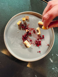 Cropped hand of person preparing food