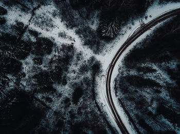 High angle view of tire tracks on road during winter