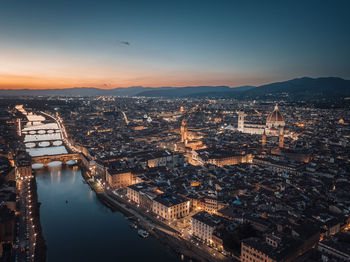 An aerial view of the illuminated city of florence at dusk and during blue hour