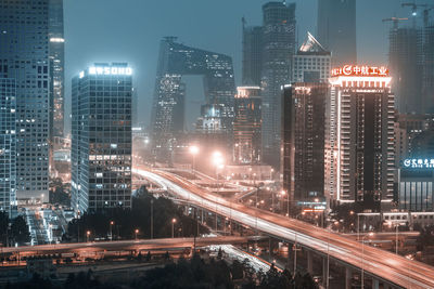 High angle view of illuminated city lit up at night