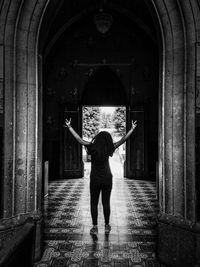 Full length rear view of man standing in building