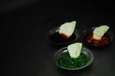 Close-up of food served on table against black background