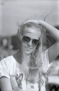 Close-up portrait of young woman wearing sunglasses