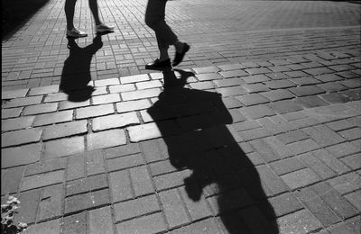 Low section of people walking on street