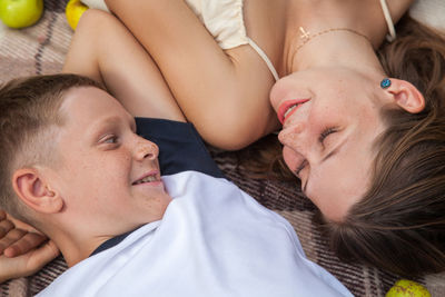 High angle portrait of woman relaxing on bed