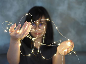 Close-up of hand holding illuminated lights