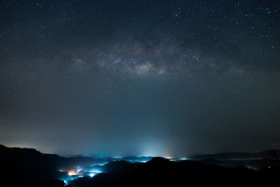 Low angle view of silhouette mountain against sky at night