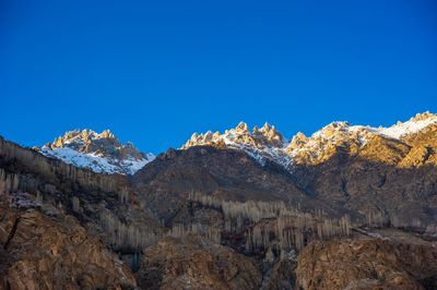 Scenic view of mountains against clear blue sky