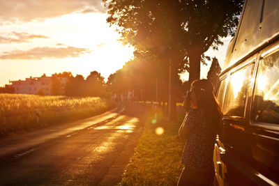 Road in city against sky at sunset