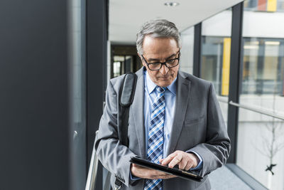 Senior businessman using digital tablet