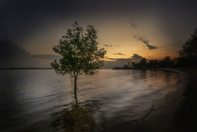 Scenic view of lake against sky during sunset