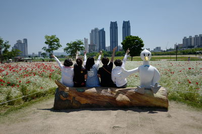 People in city against sky