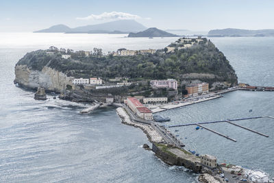 High angle view of sea and mountains against sky