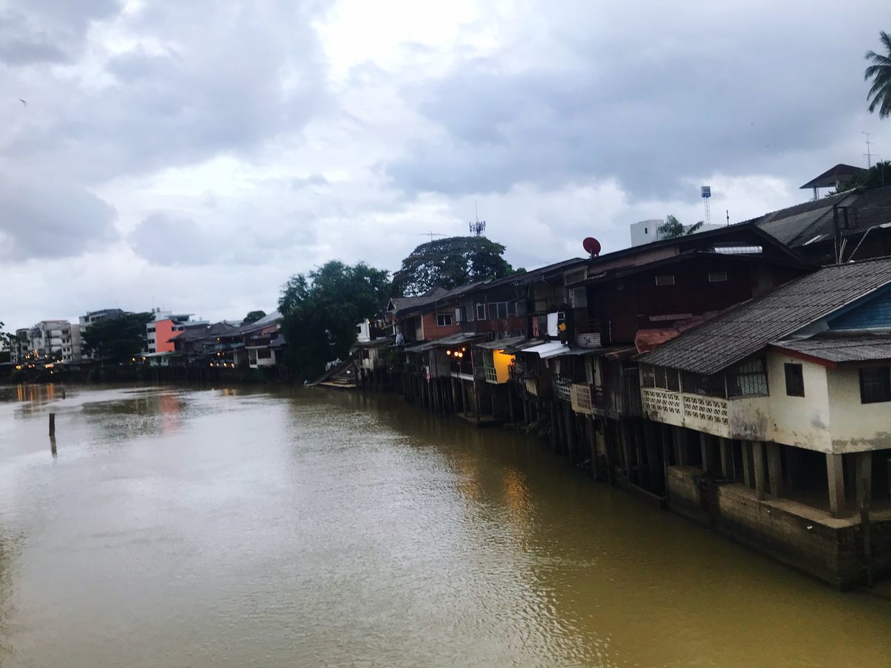 RIVER BY HOUSES AGAINST SKY