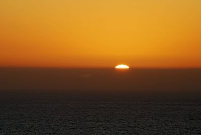 Scenic view of sea against romantic sky at sunset