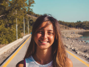 Close-up portrait of smiling young woman