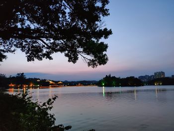 Scenic view of lake against sky at sunset