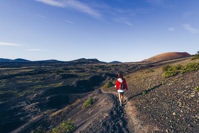 Woman on mountain against sky