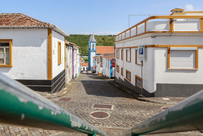 Street amidst buildings against clear sky