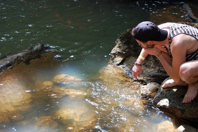 Man washing face in lake