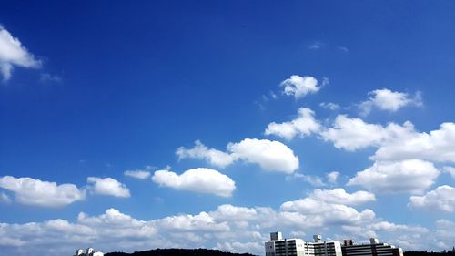 Low angle view of buildings against blue sky