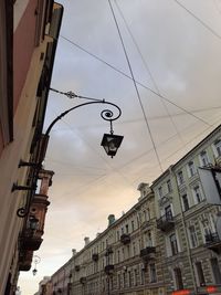Low angle view of street light and buildings against sky