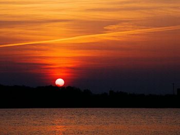 Scenic view of dramatic sky over sea during sunset