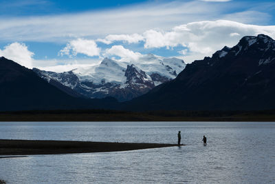 Scenic view of lake against cloudy sky